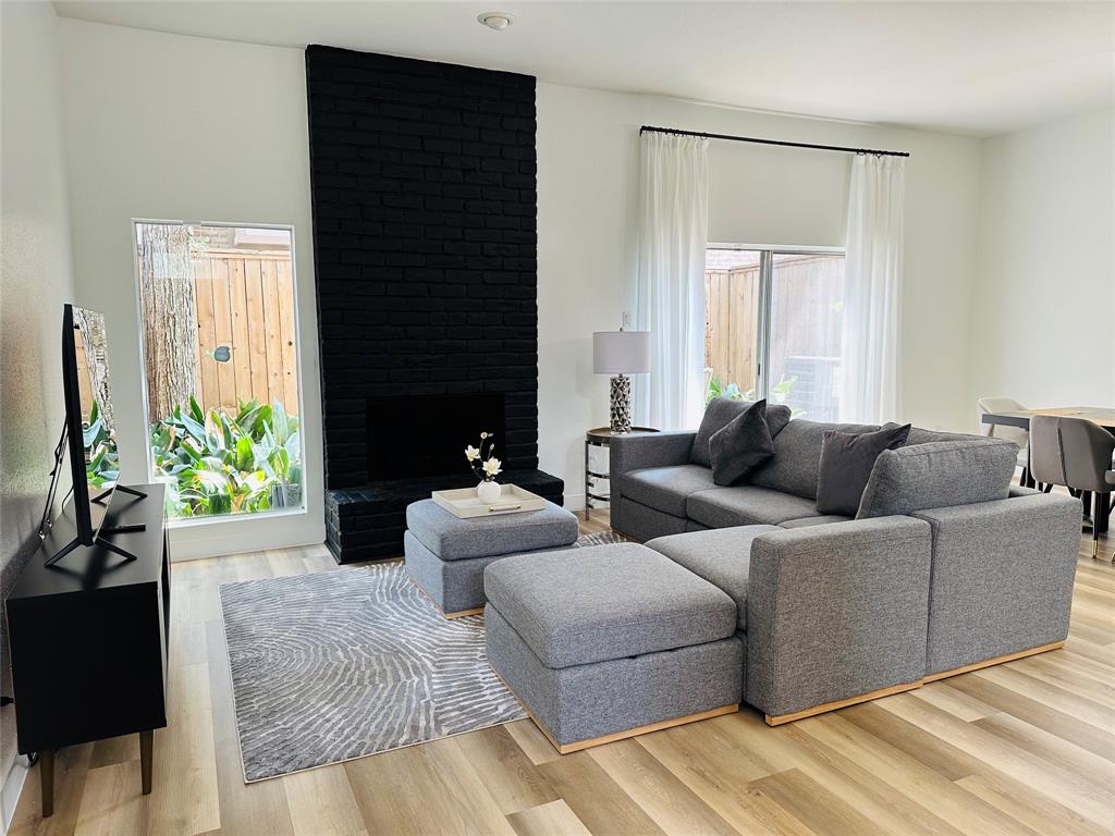 a living room with furniture and a potted plant