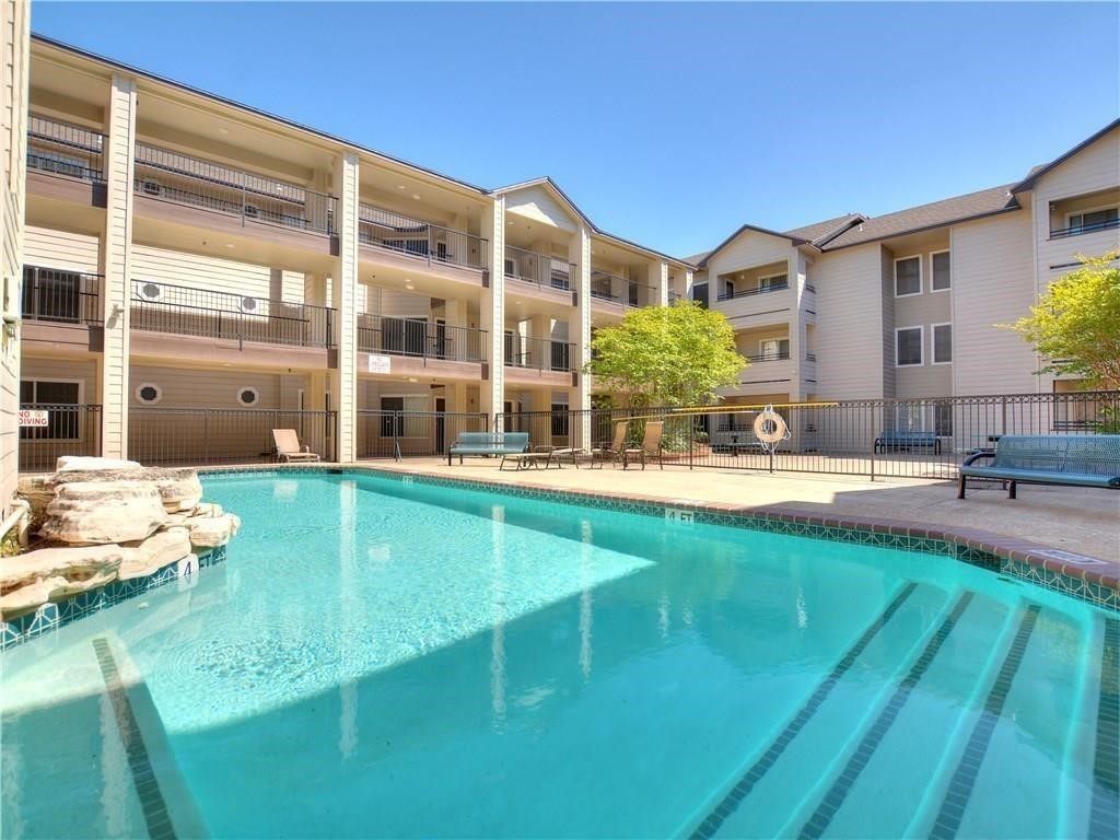 a swimming pool with outdoor seating and yard