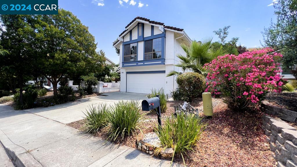 a front view of a house with a yard and fountain in middle