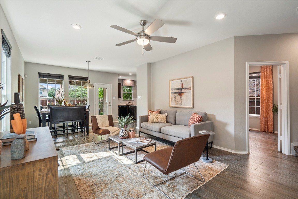 a living room with furniture and wooden floor