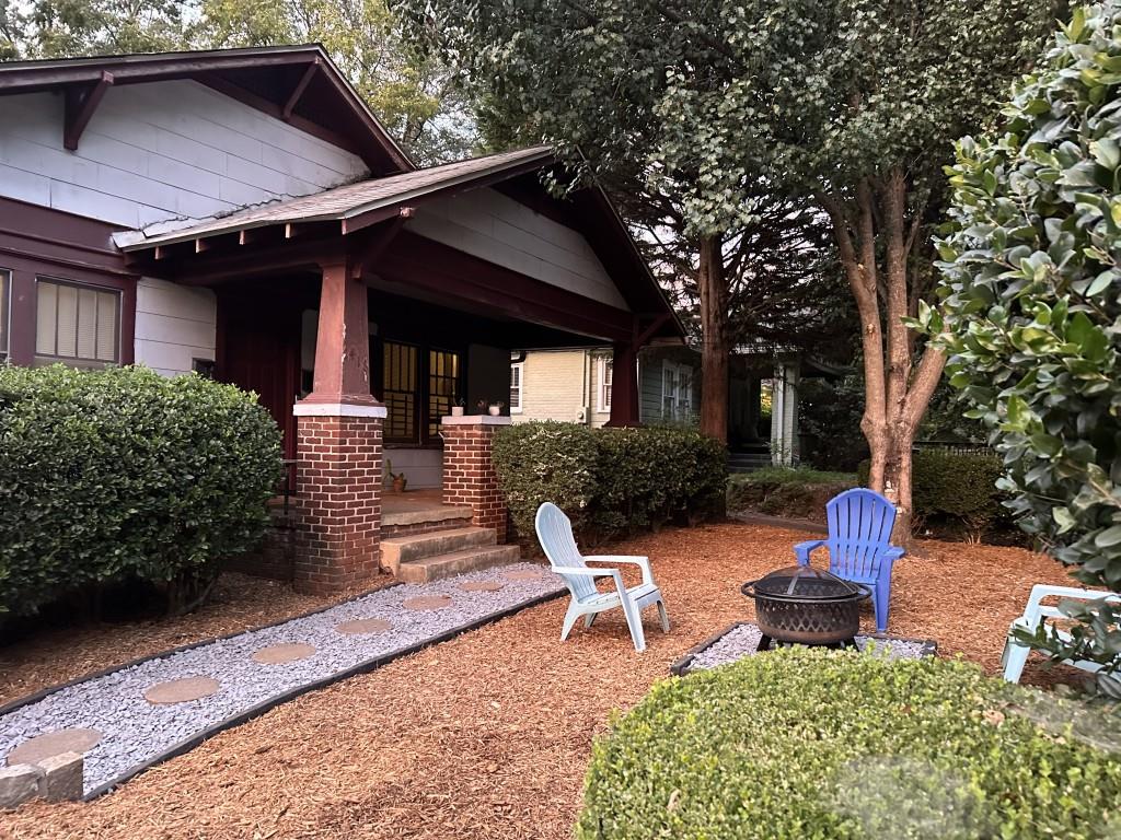 a front view of a house with a yard garage and outdoor seating