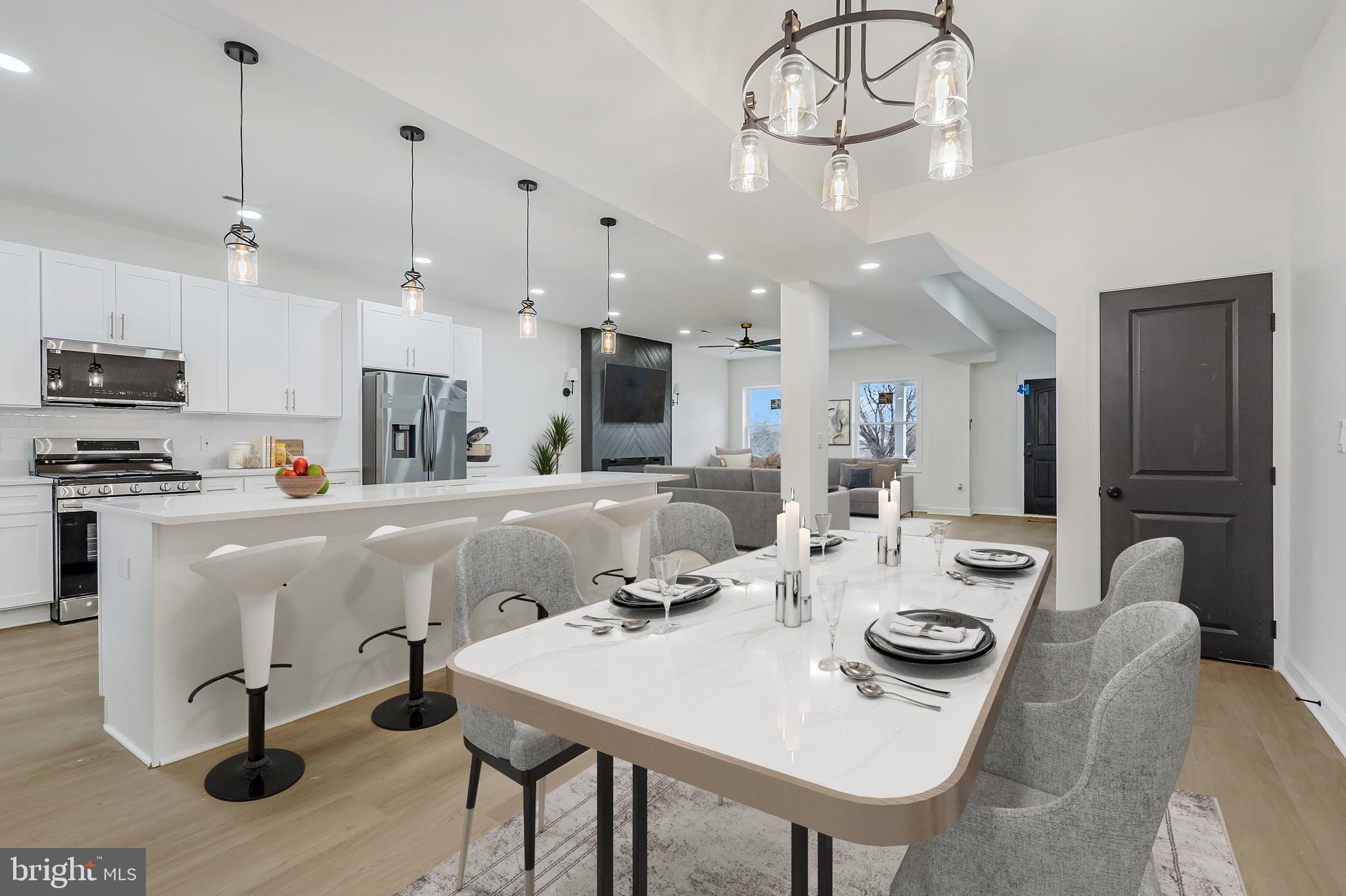 a large kitchen with a table and chairs