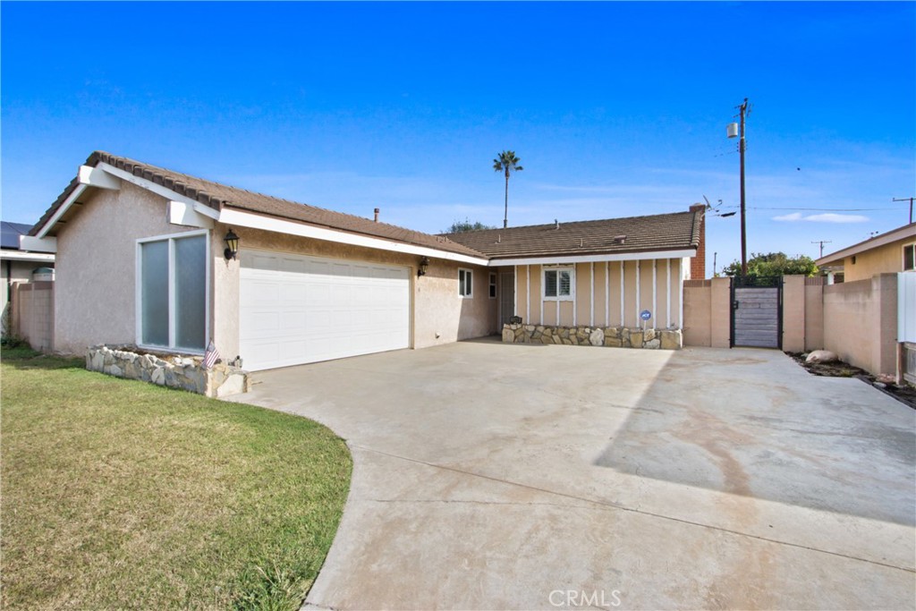 a view of a house with a backyard and garage