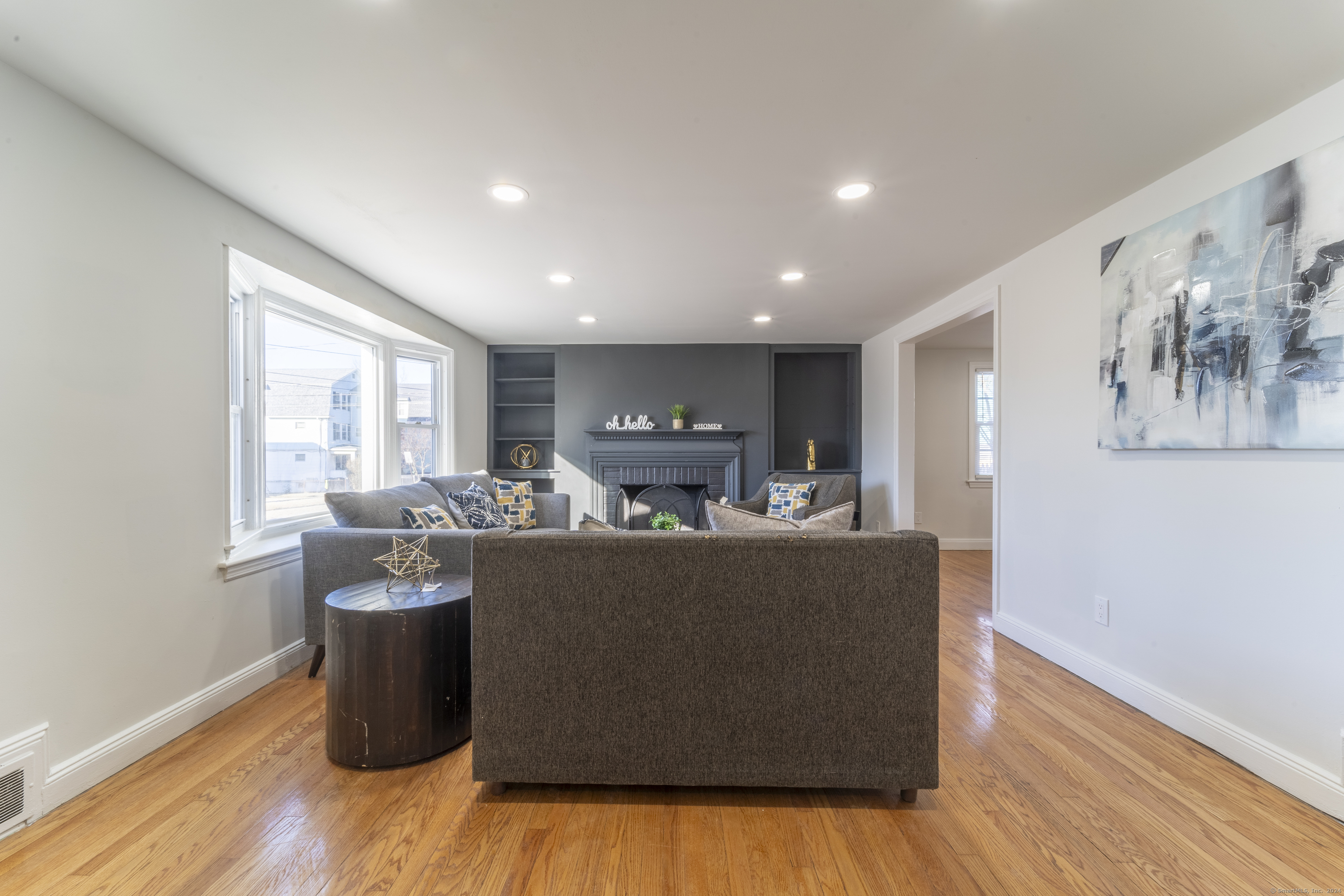 a living room with kitchen island furniture and a wooden floor