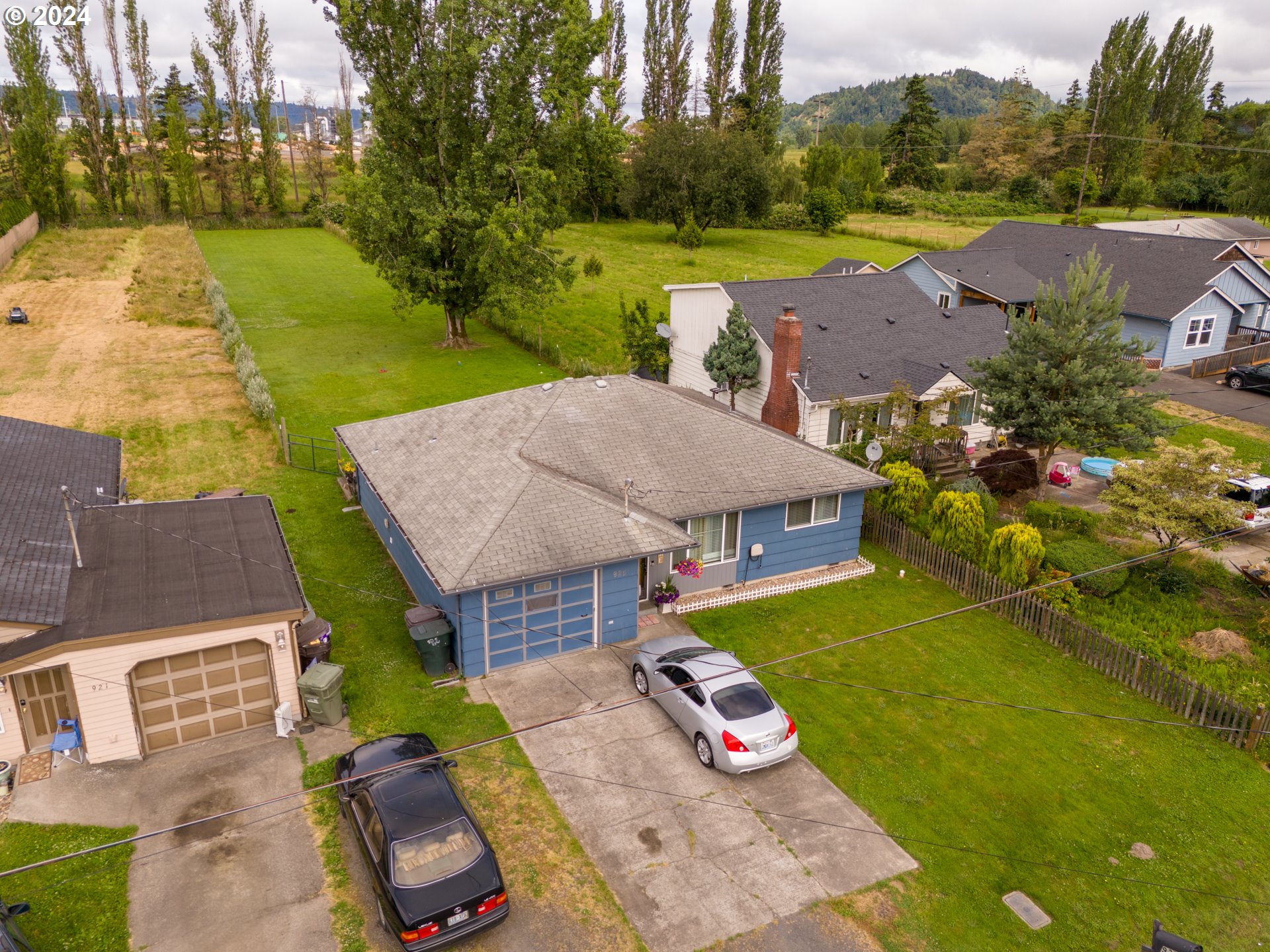 an aerial view of a house with big yard