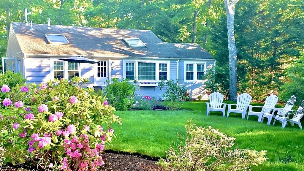 a front view of a house with a garden