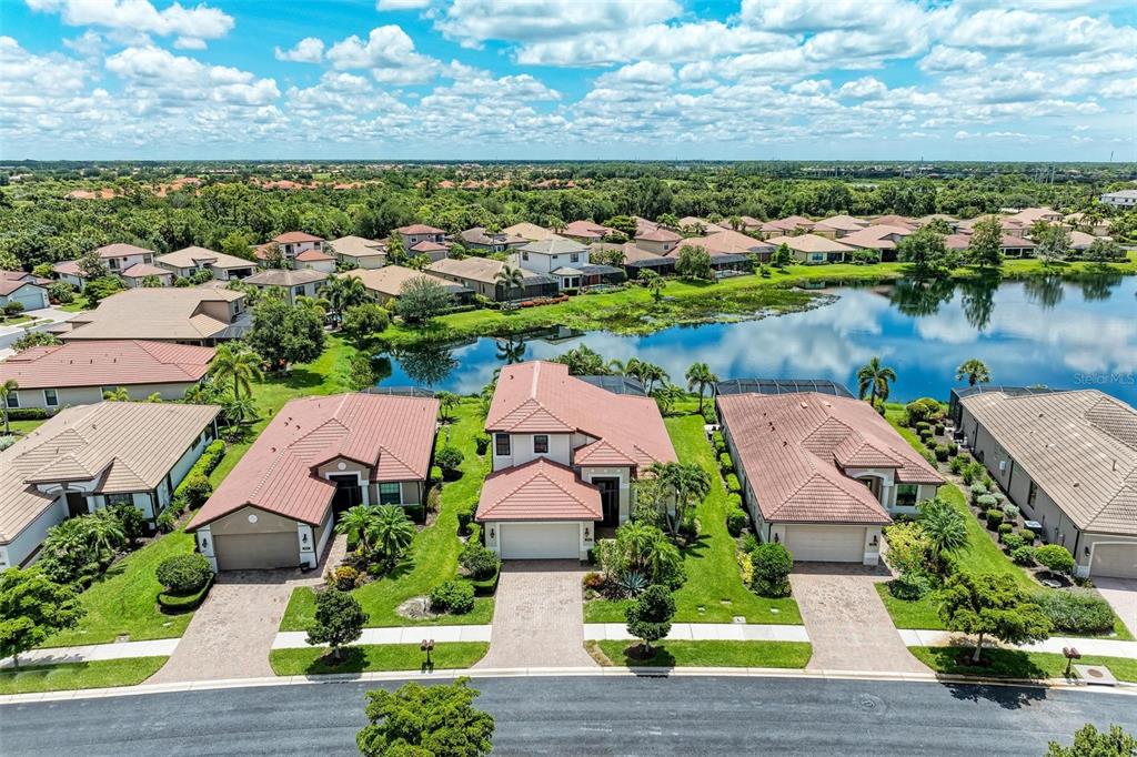 an aerial view of residential houses with outdoor space and river