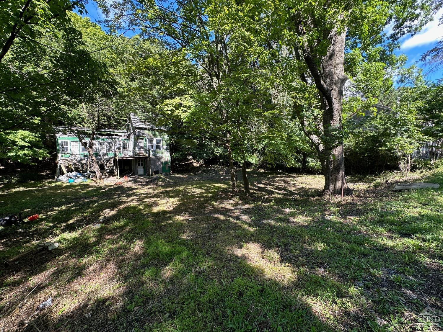 a backyard of a house with lots of green space