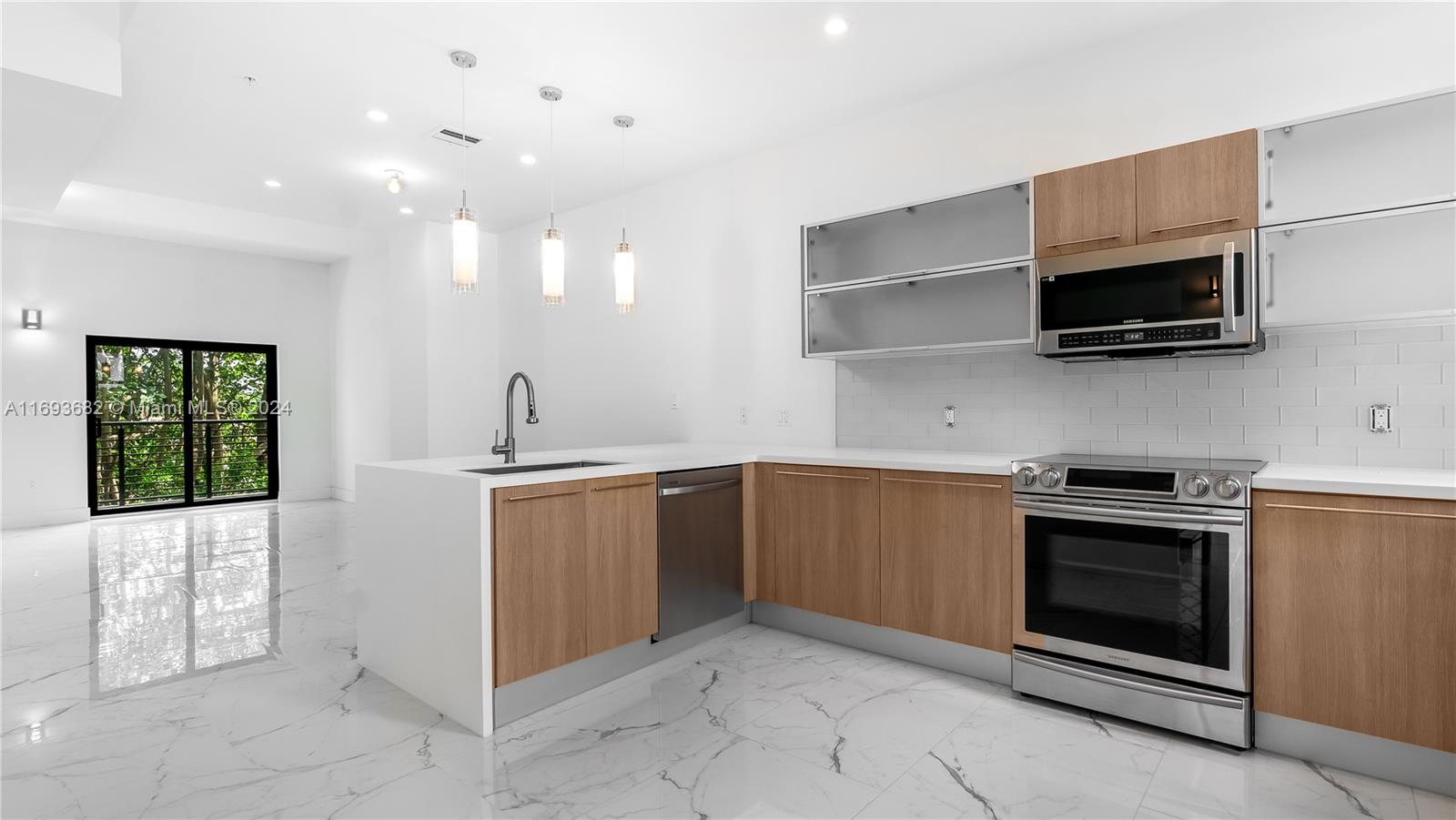 a kitchen with a sink and stainless steel appliances