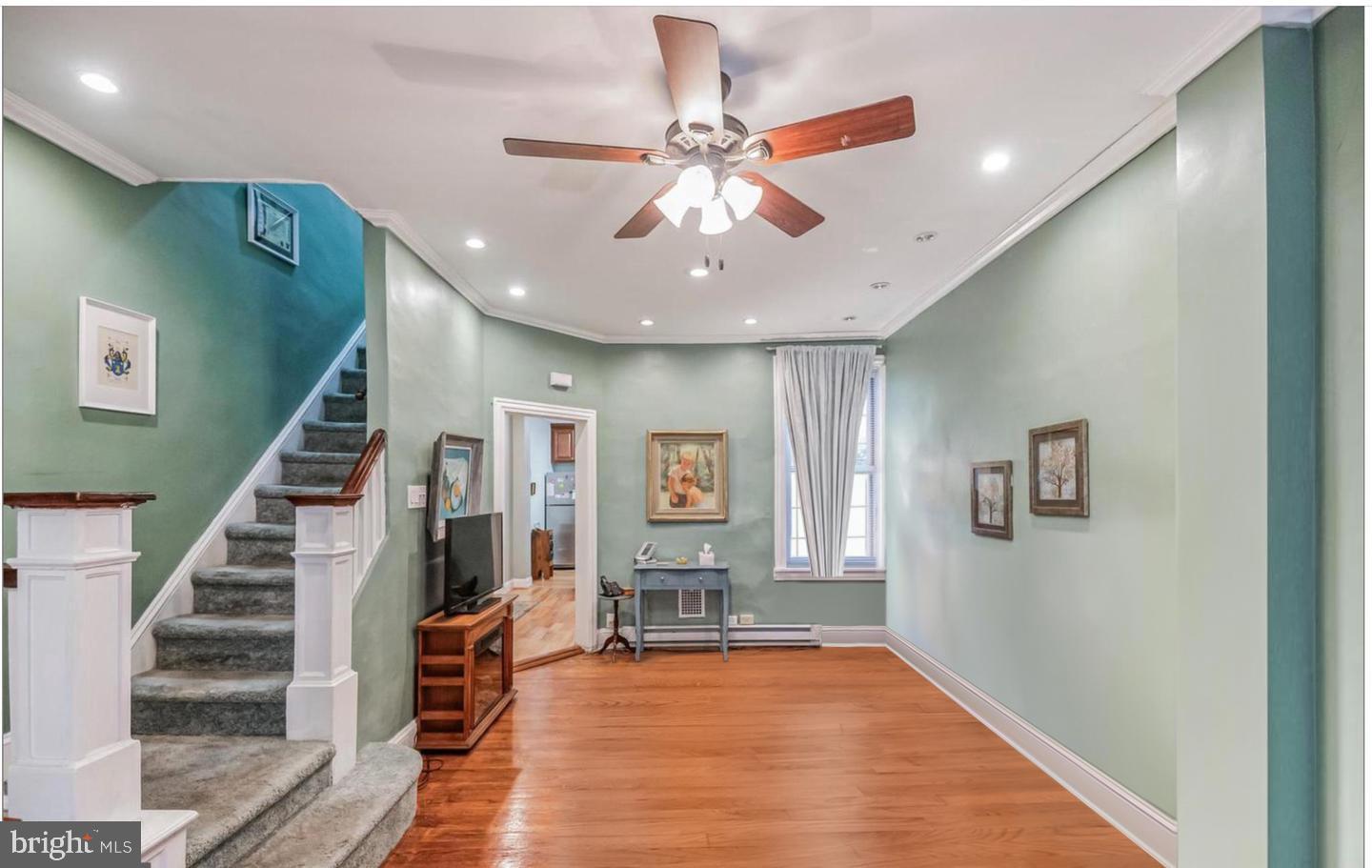 a view of an entryway with wooden floor and stairs