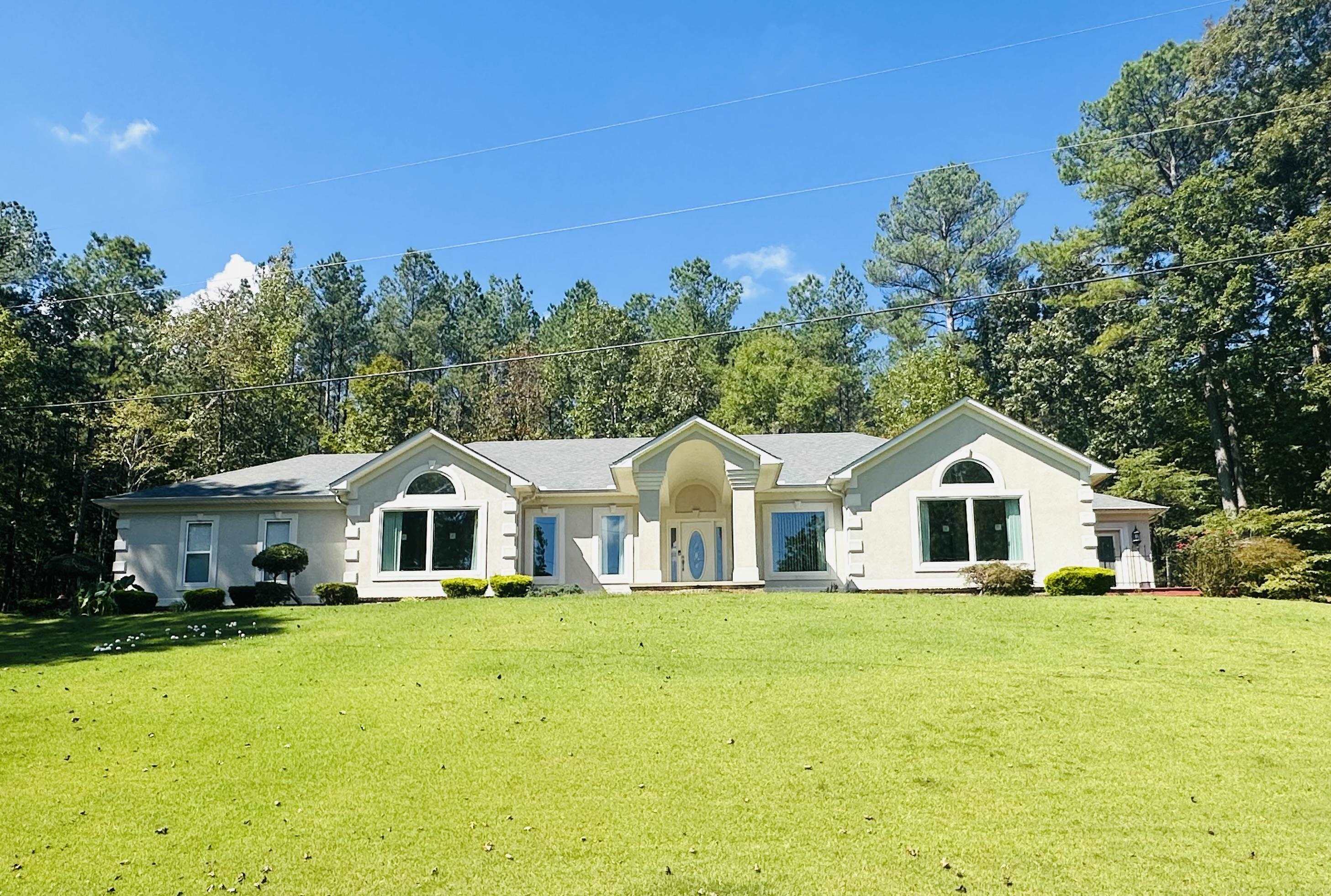 a front view of house with yard and green space