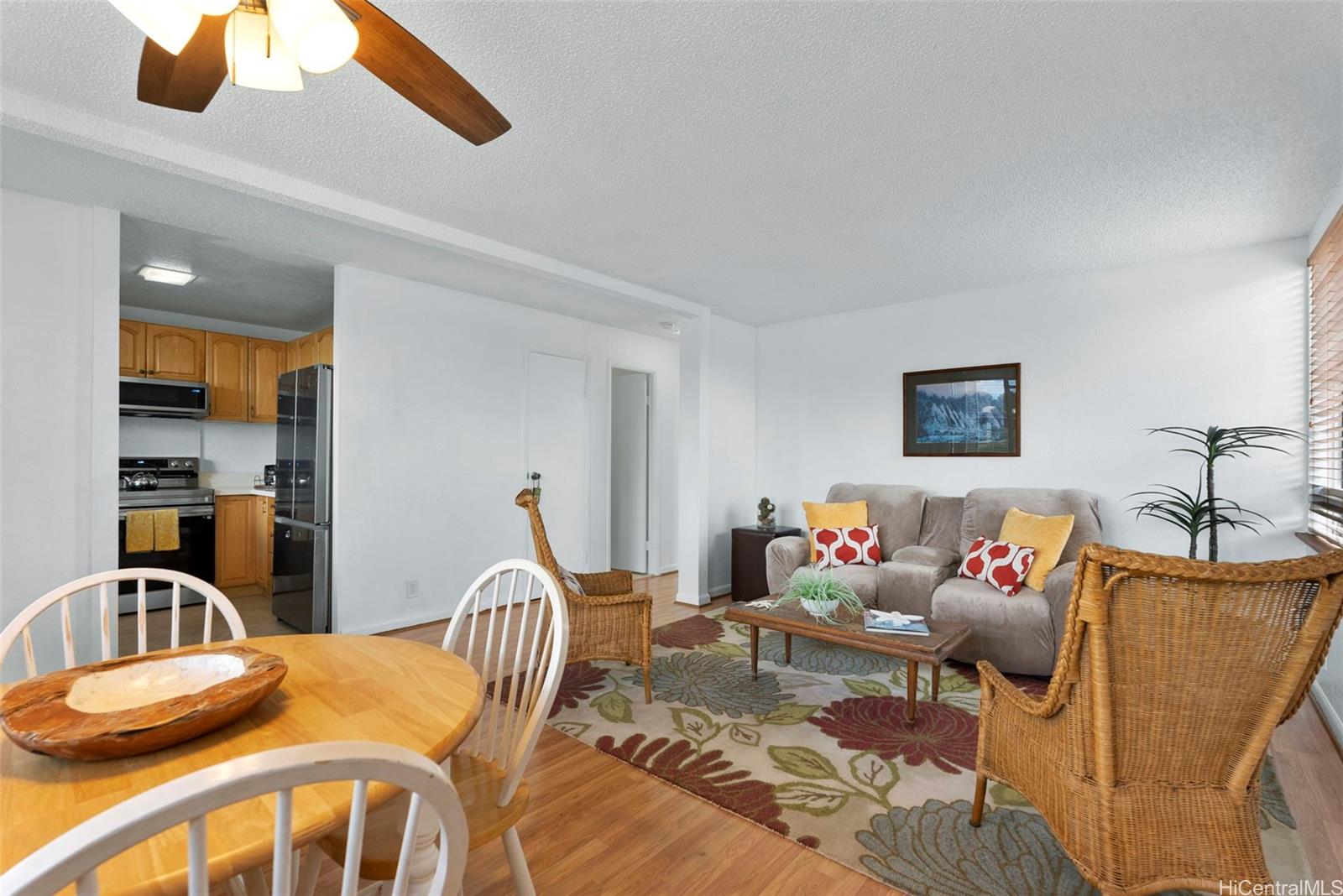 a bedroom with furniture and a large window