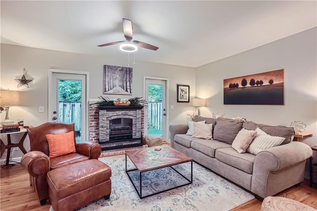 a living room with furniture a fireplace and a flat screen tv