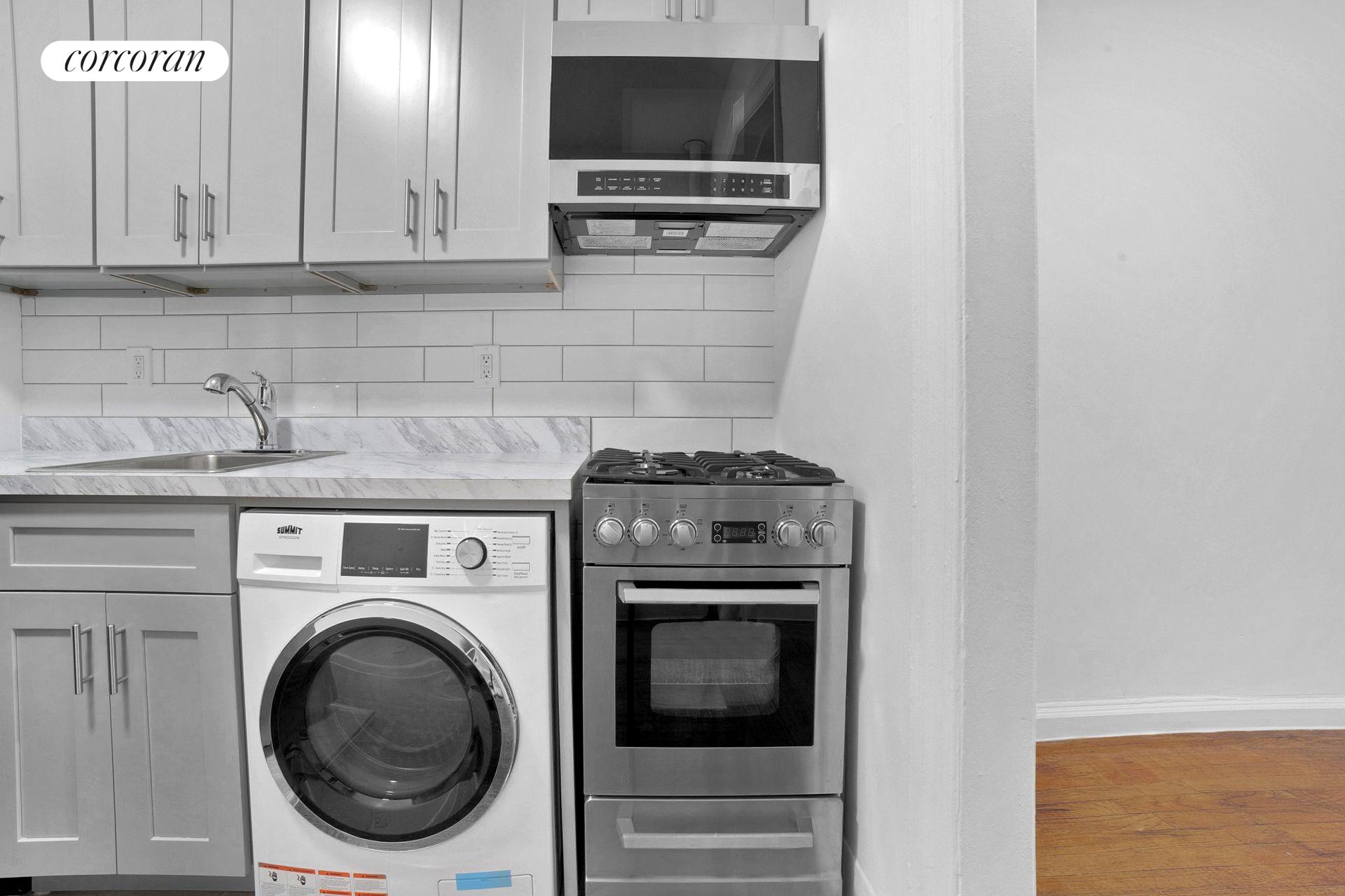 a kitchen with a stove and a microwave