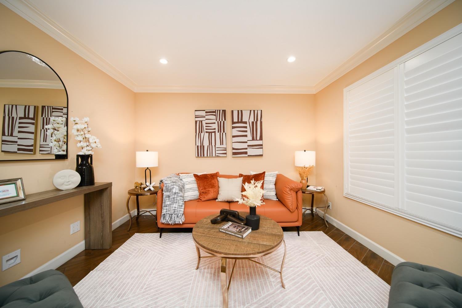 a living room with furniture and painting on the wall