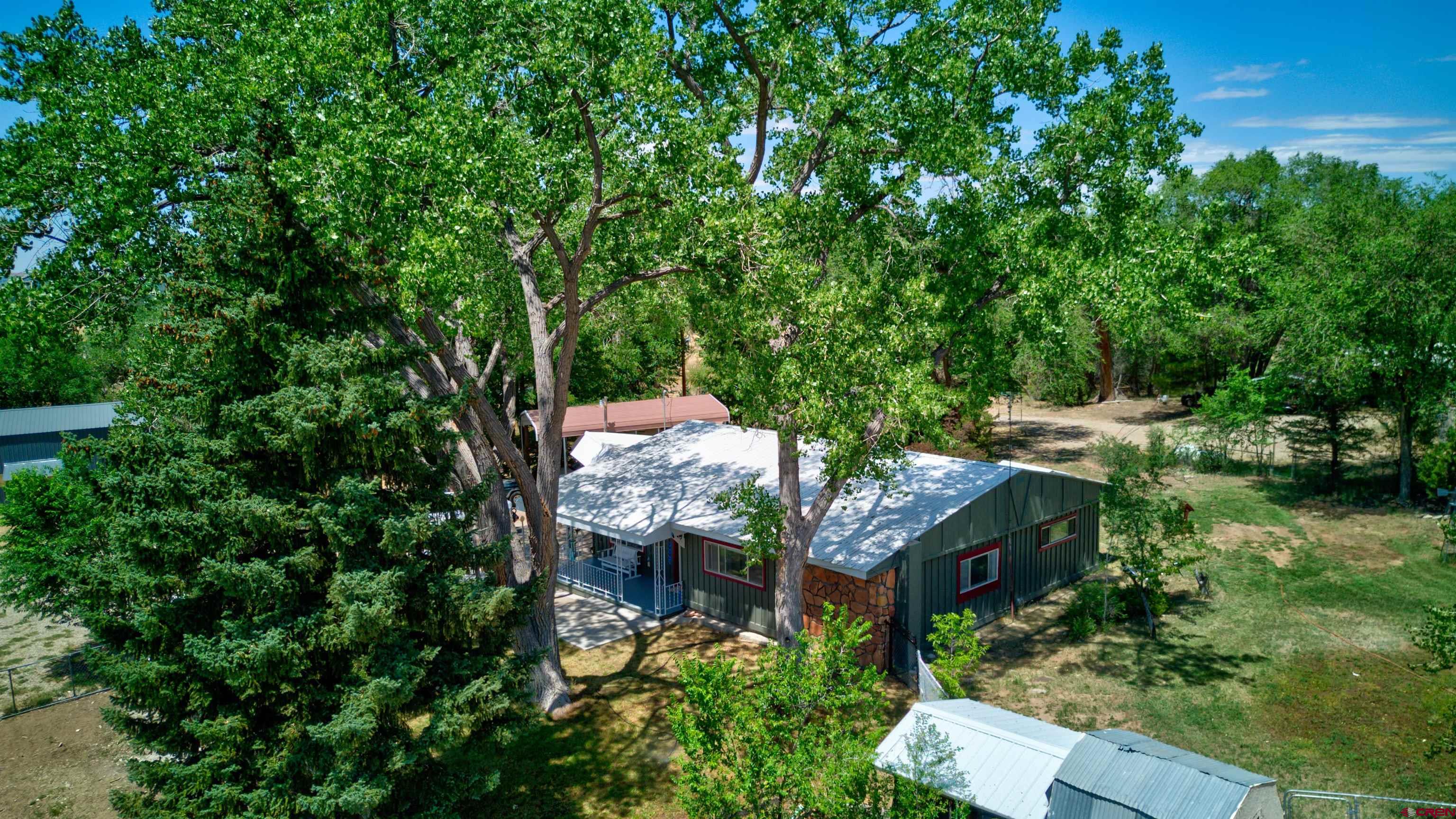 an aerial view of a house with a yard