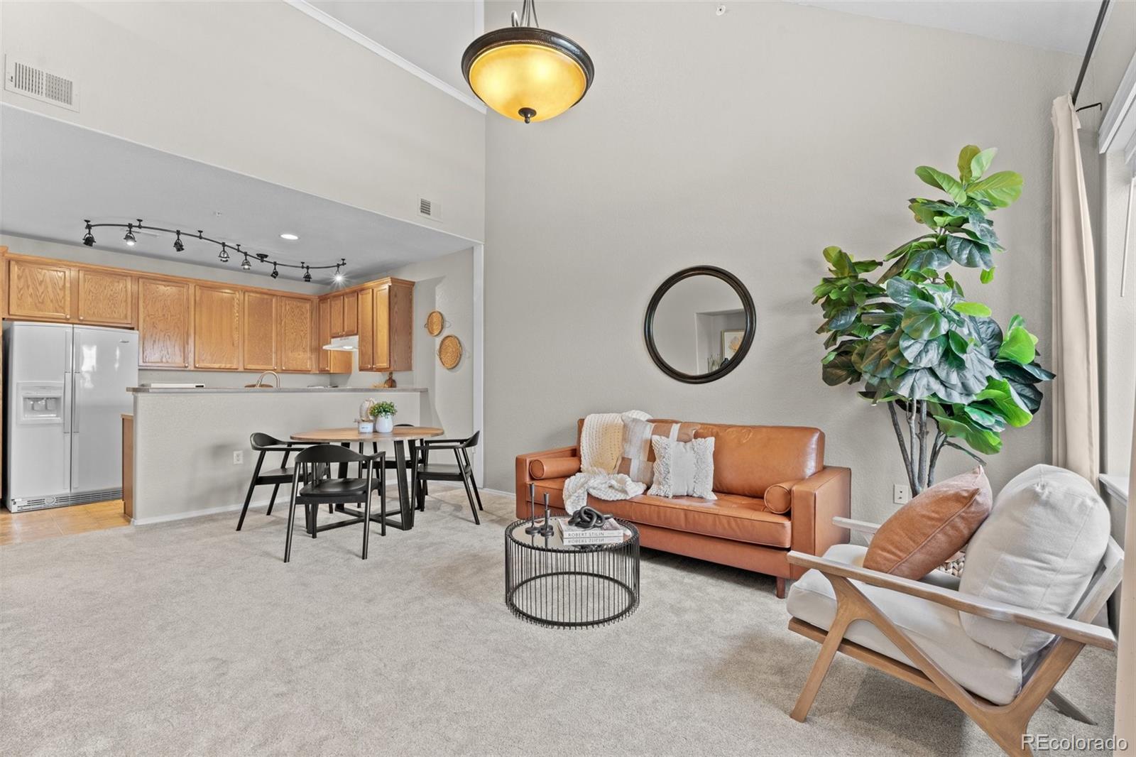 a living room with furniture potted plant and a large window