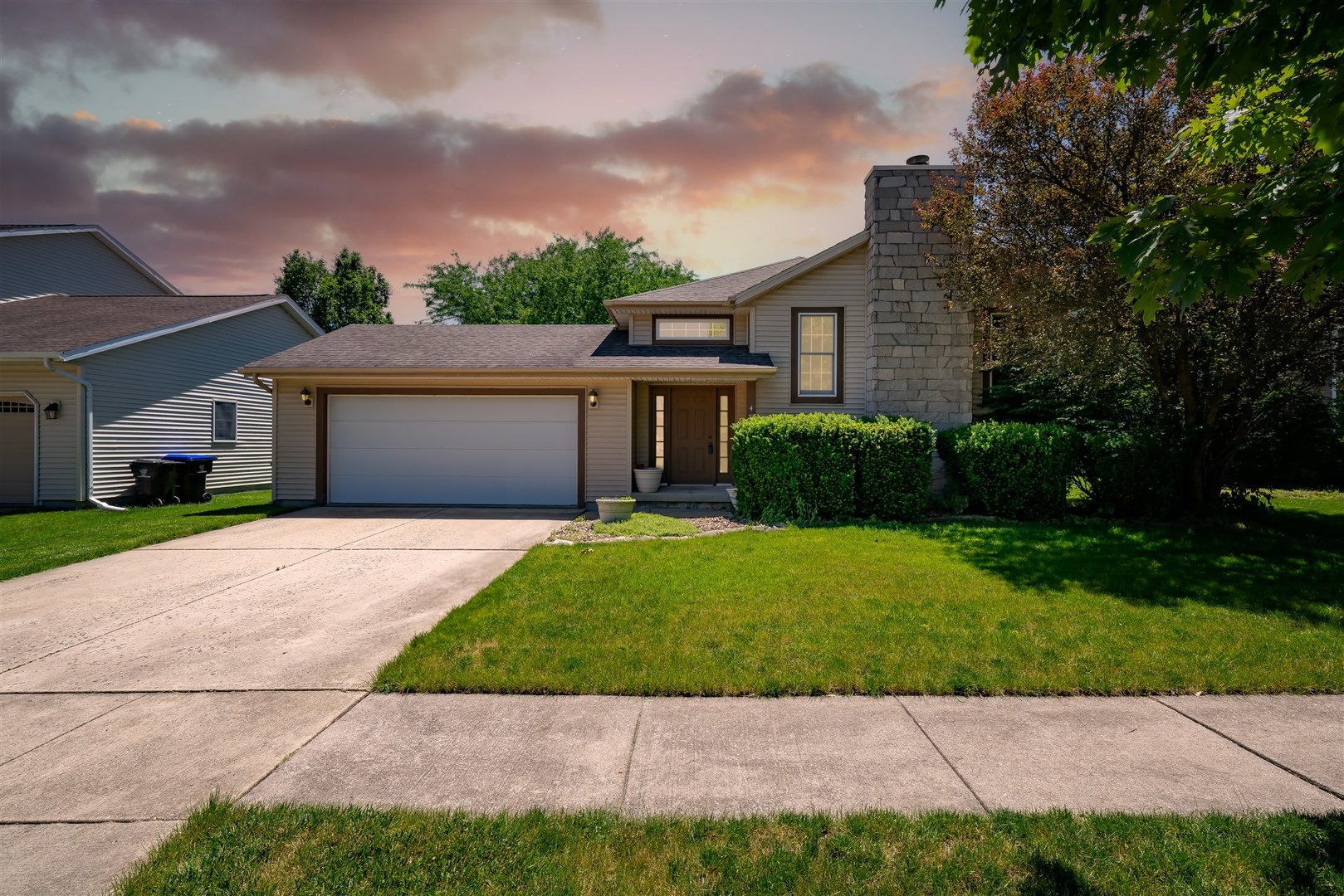 a front view of a house with a garden