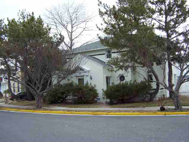 a view of house with outdoor space and large trees