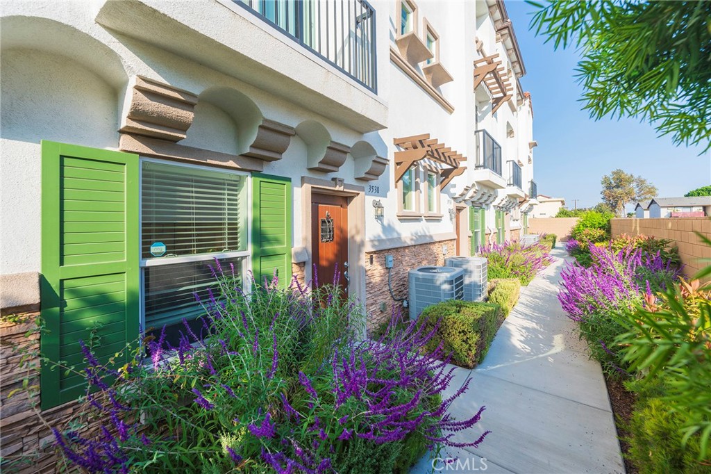 a view of a house with a flower garden