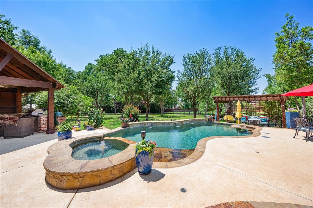 a view of a swimming pool with back yard of a house