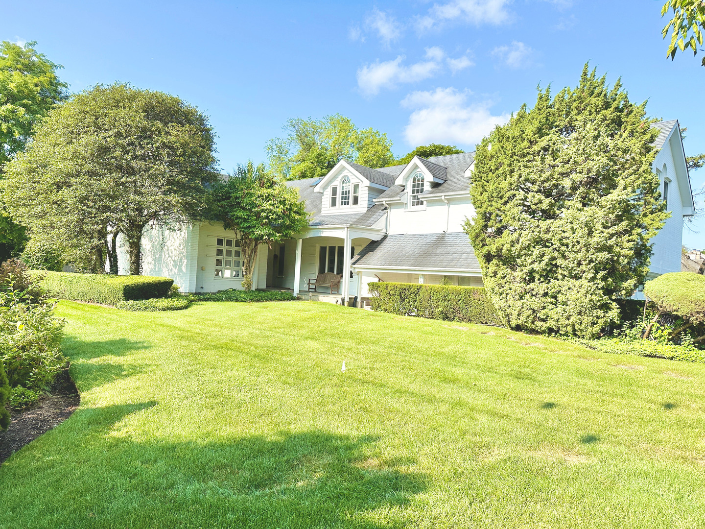 a front view of a house with a garden