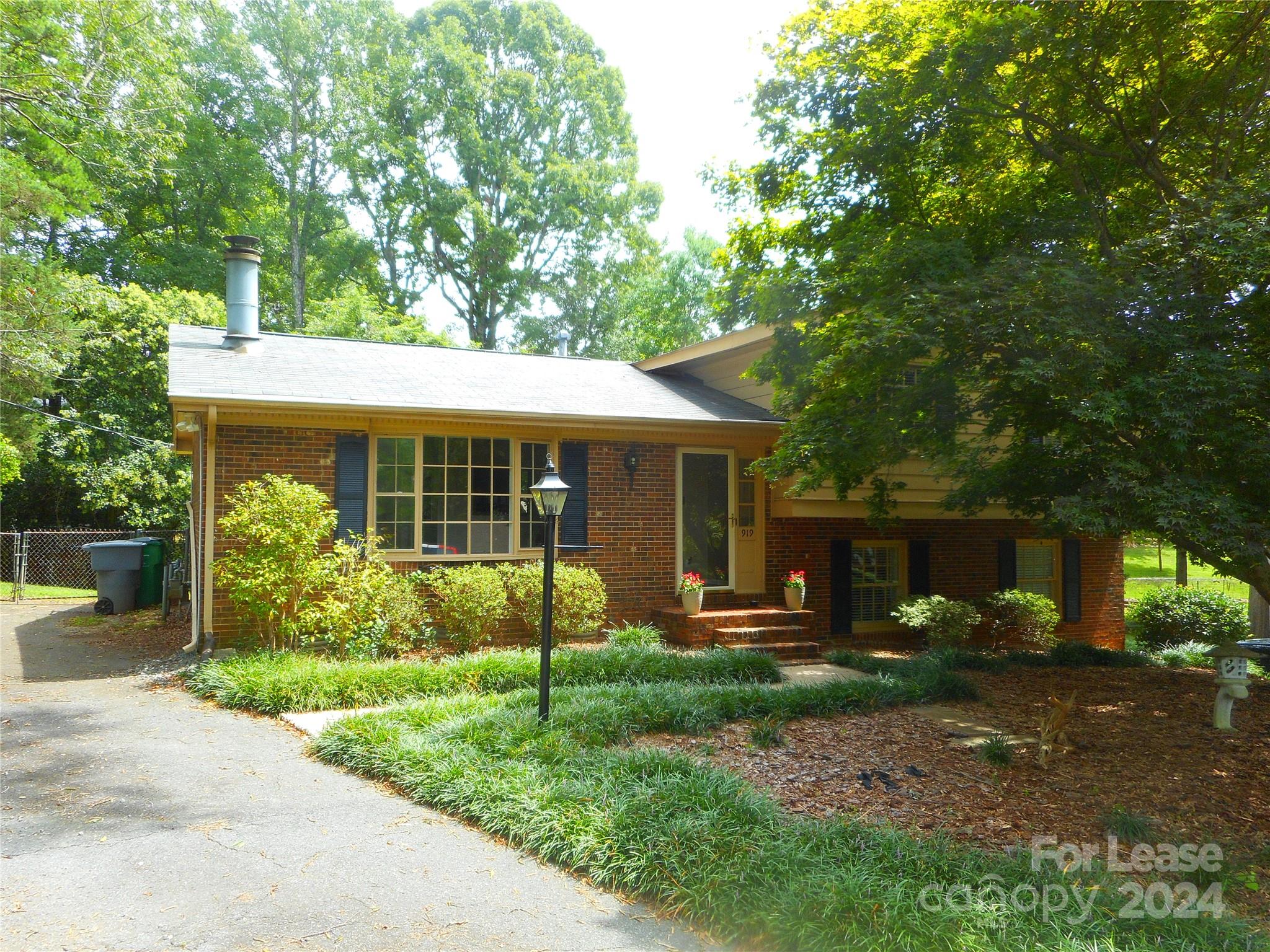 a view of a house with next to a yard