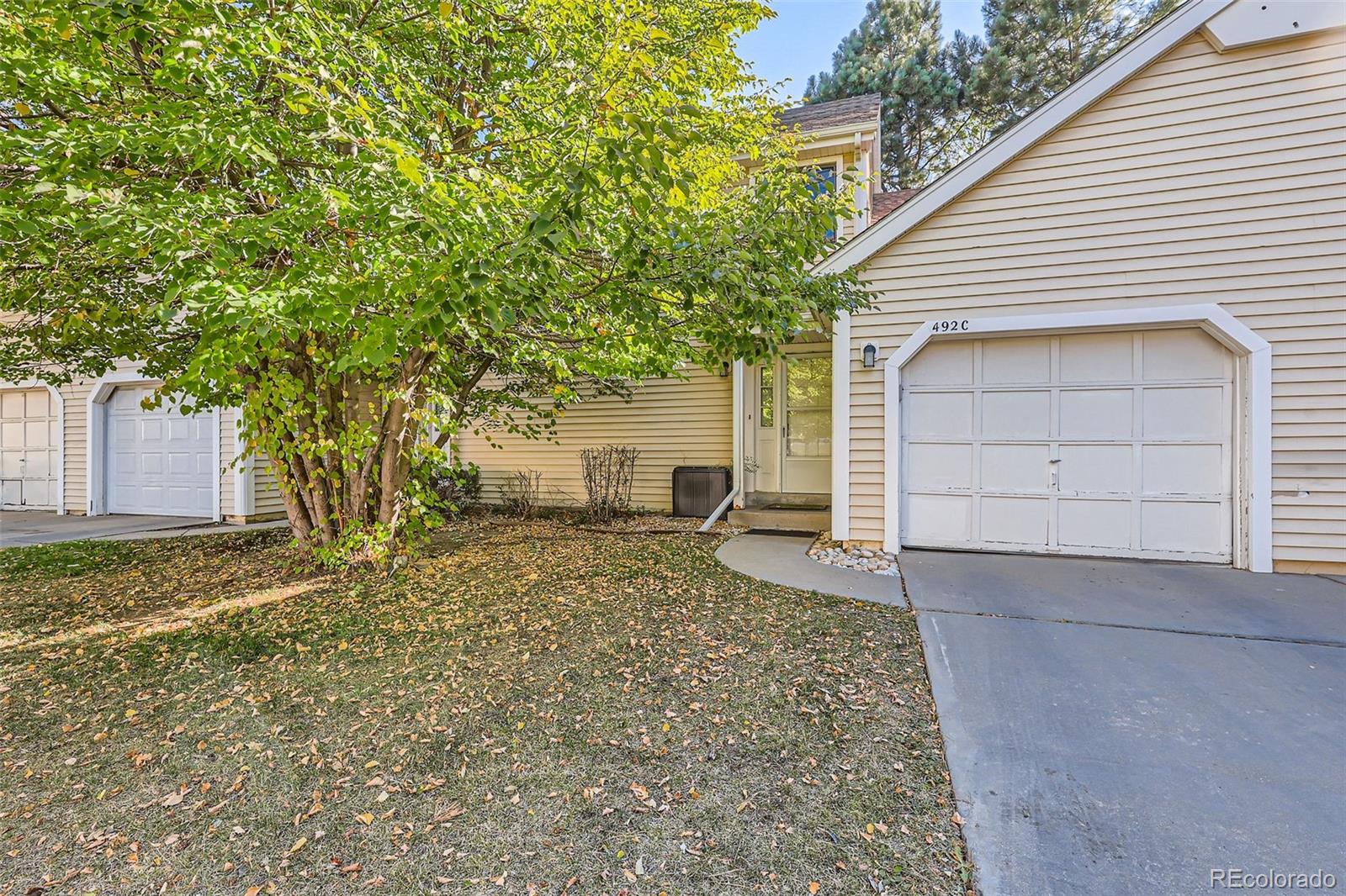 a view of a house with a yard and garage