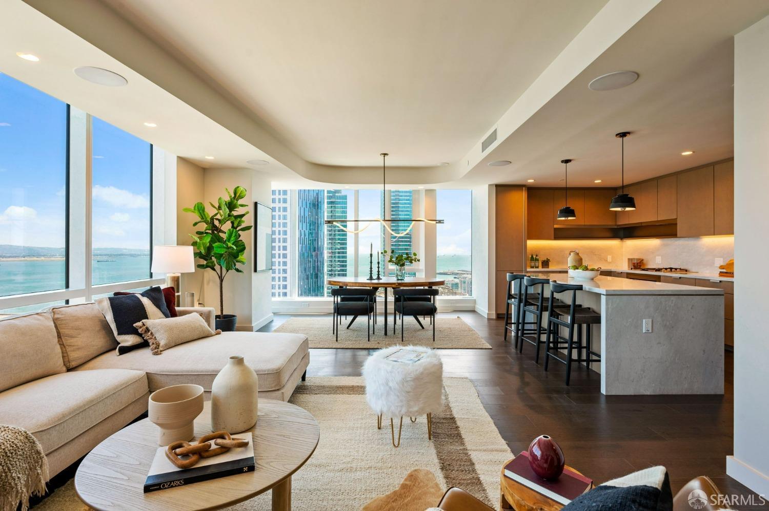 a living room with furniture kitchen view and a large window