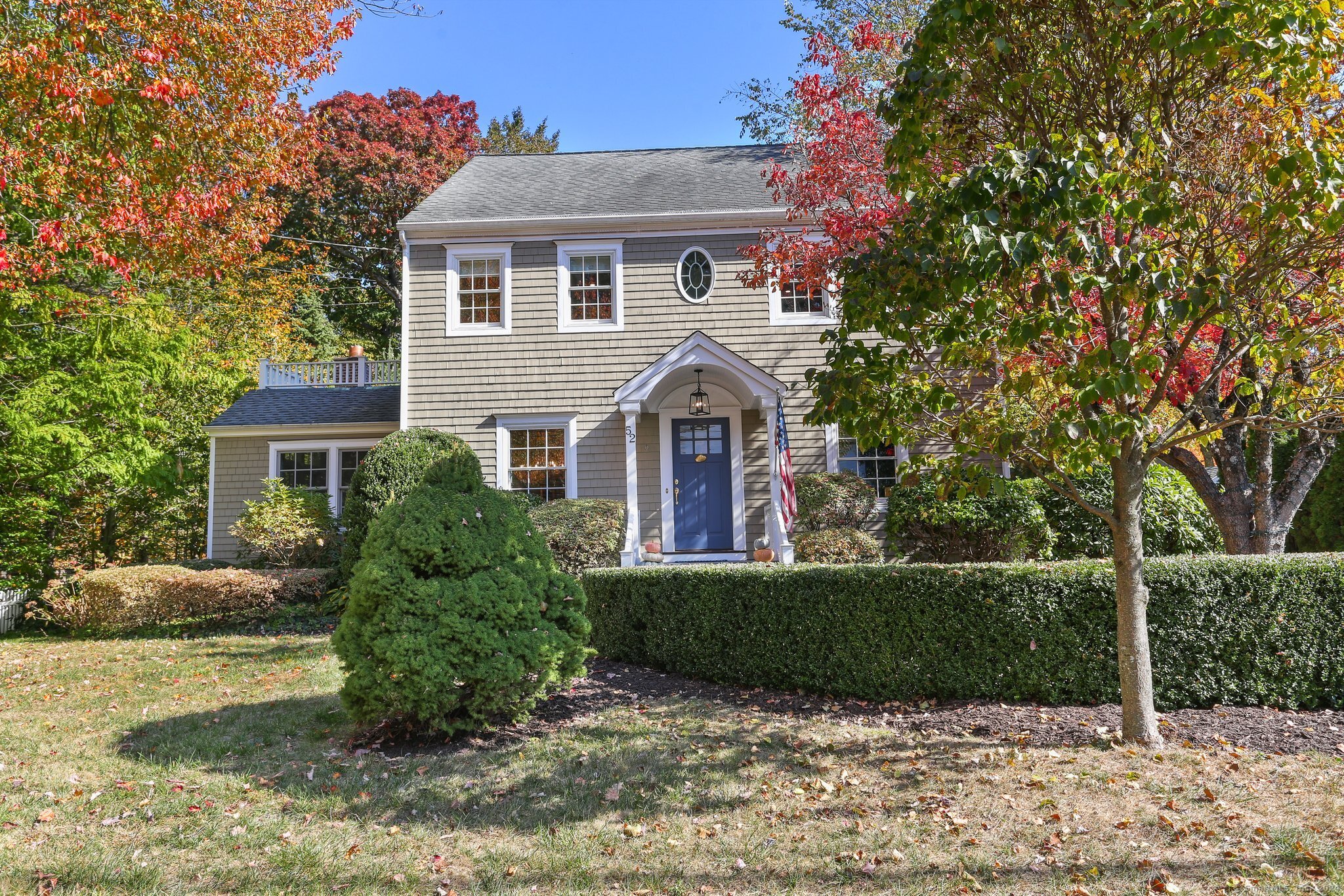 a front view of a house with a garden