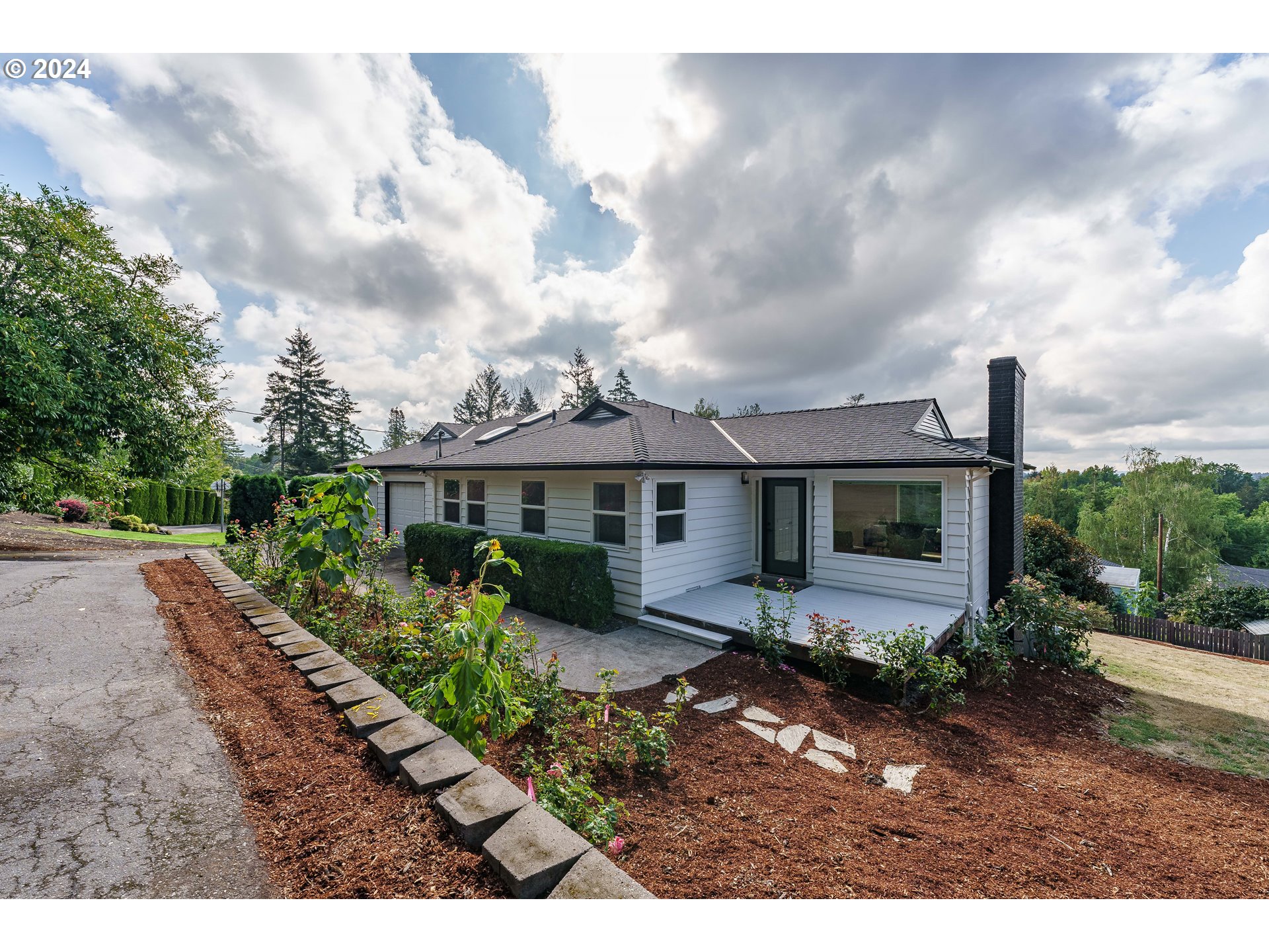 a view of a house with backyard and sitting area