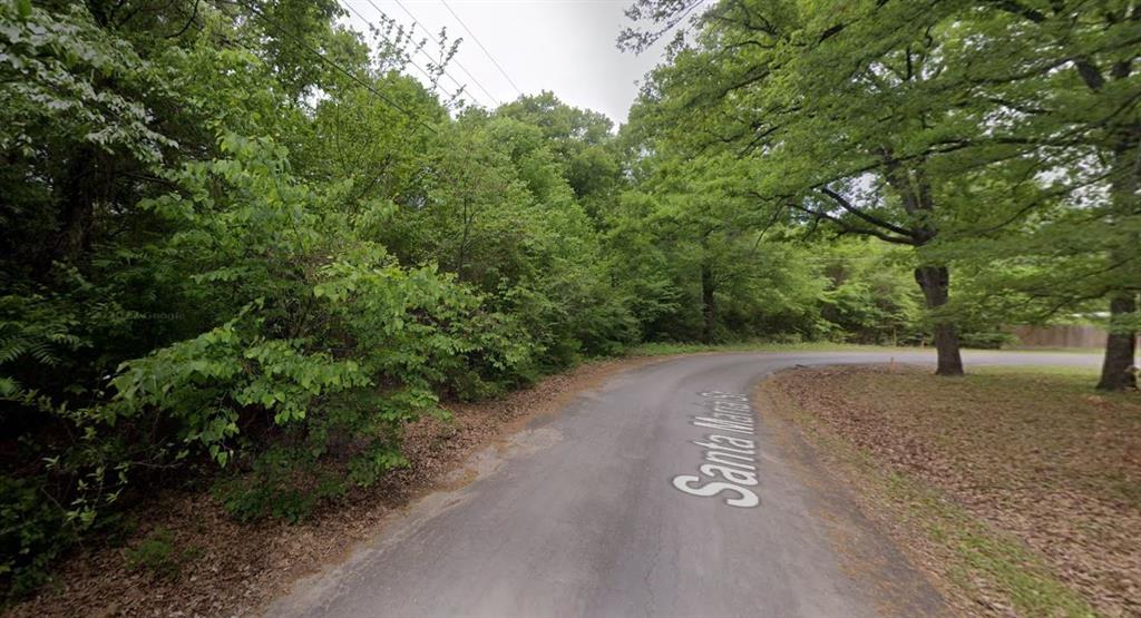 a view of a street with trees on both side of the road