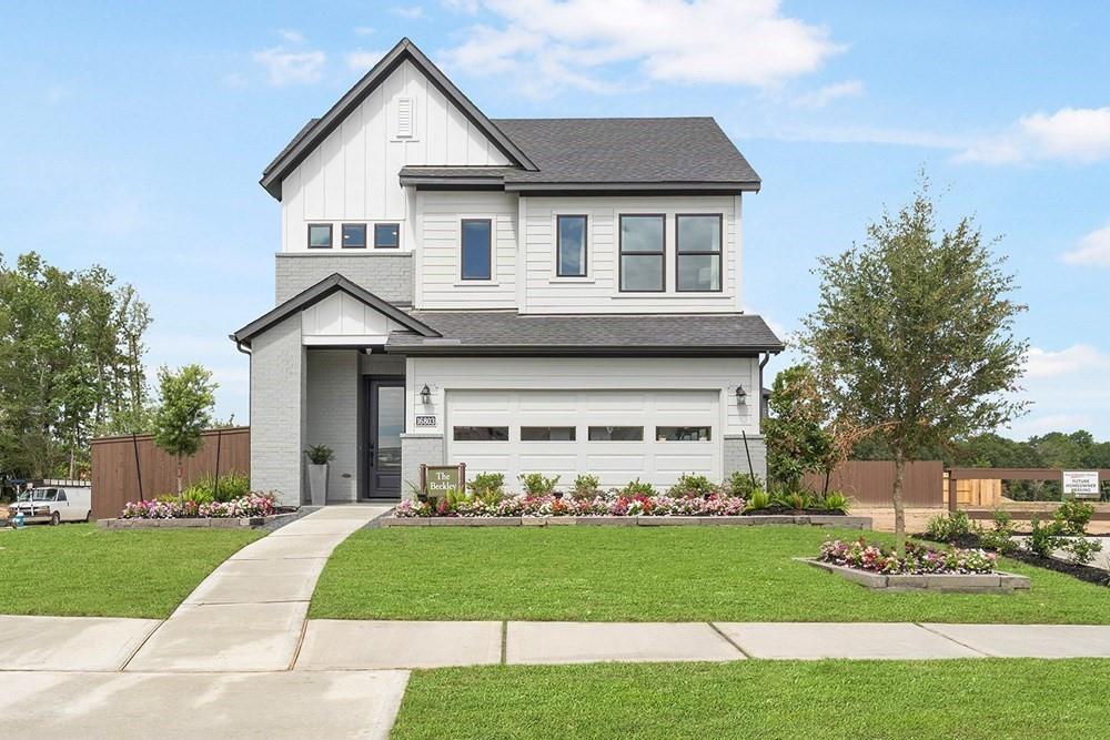 a front view of a house with a yard and garage