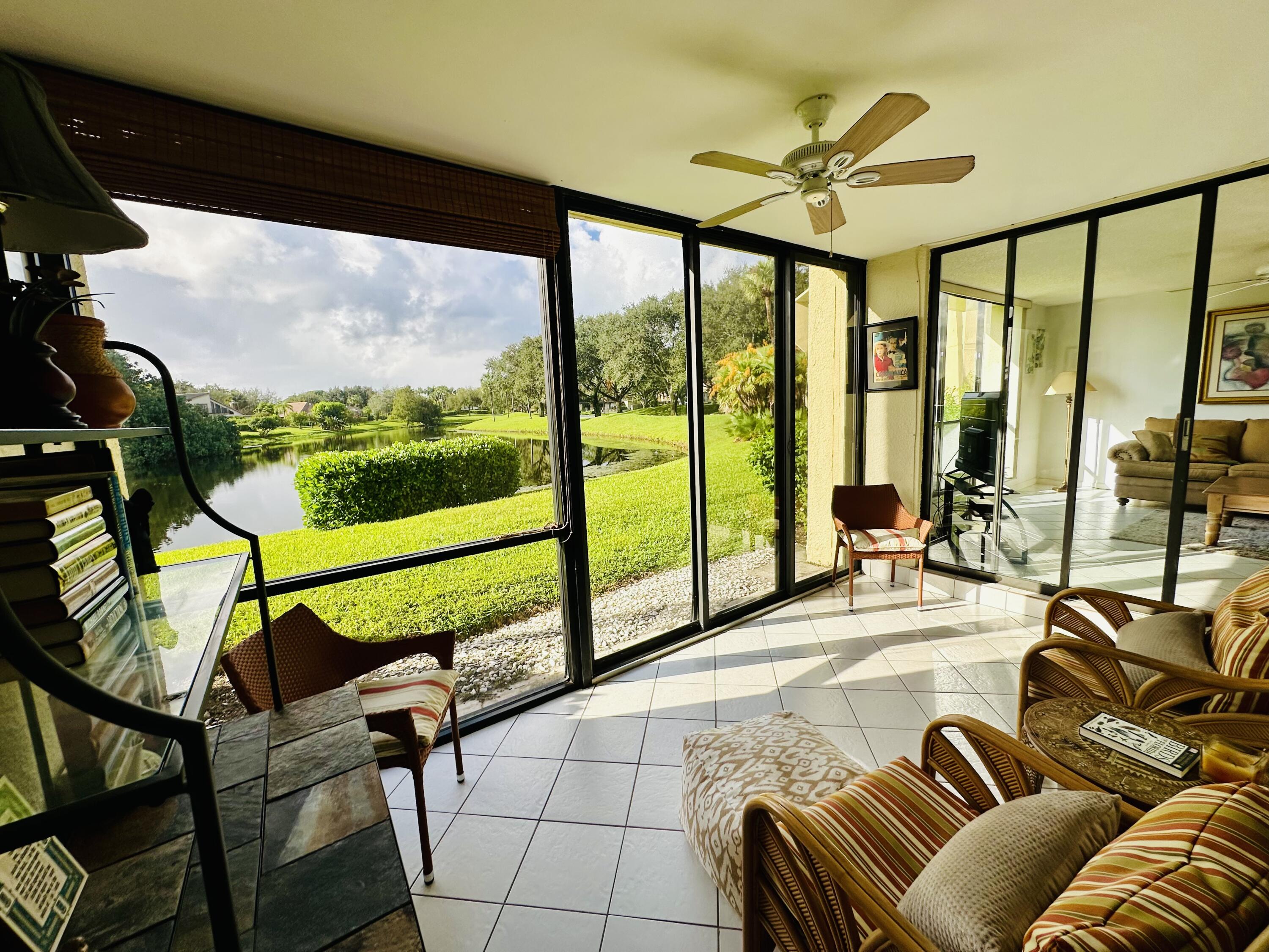 a living room with furniture and a floor to ceiling window