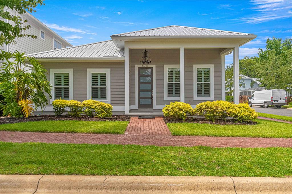 a front view of a house with garden