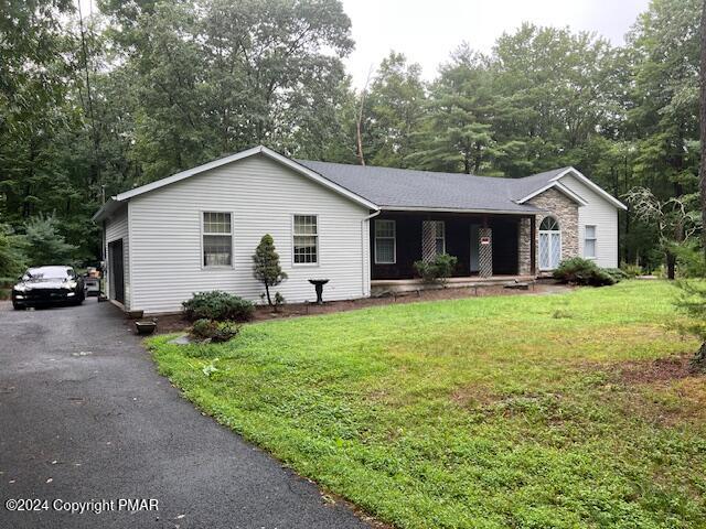 a front view of house with yard and green space