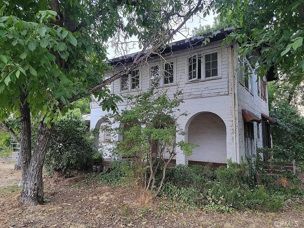 a front view of a house with plants