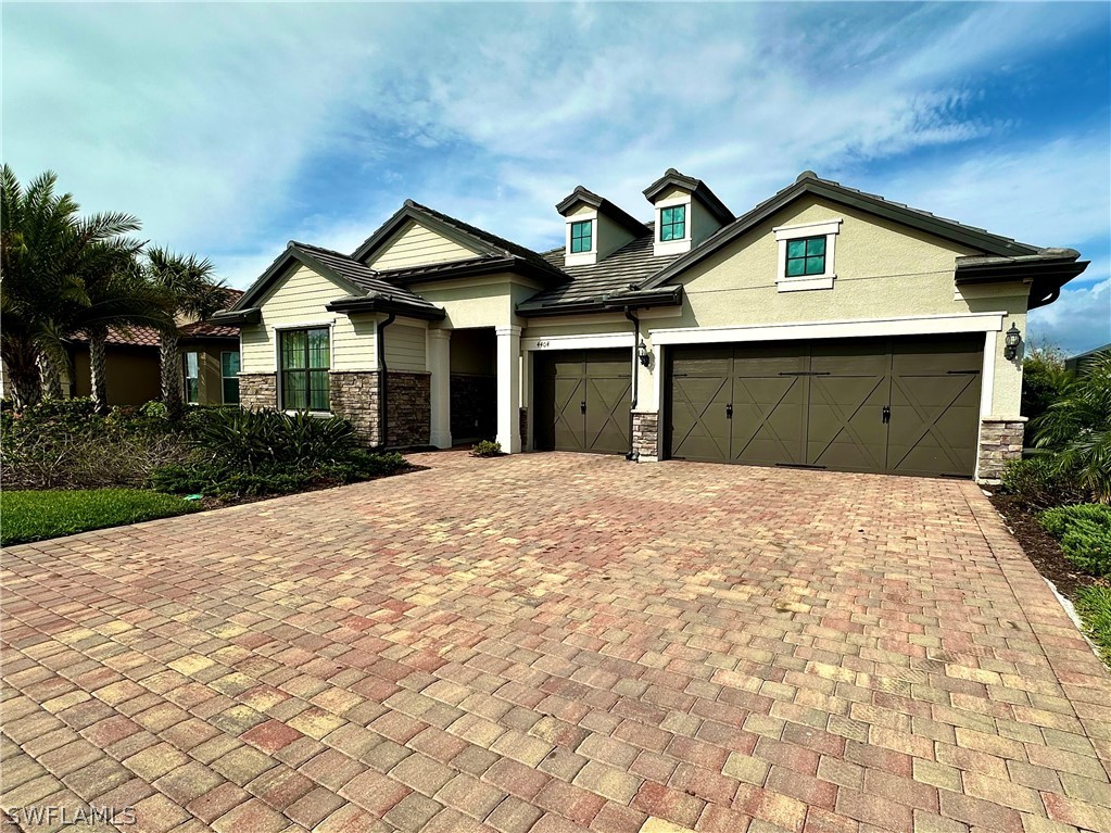 a front view of a house with a yard and garage