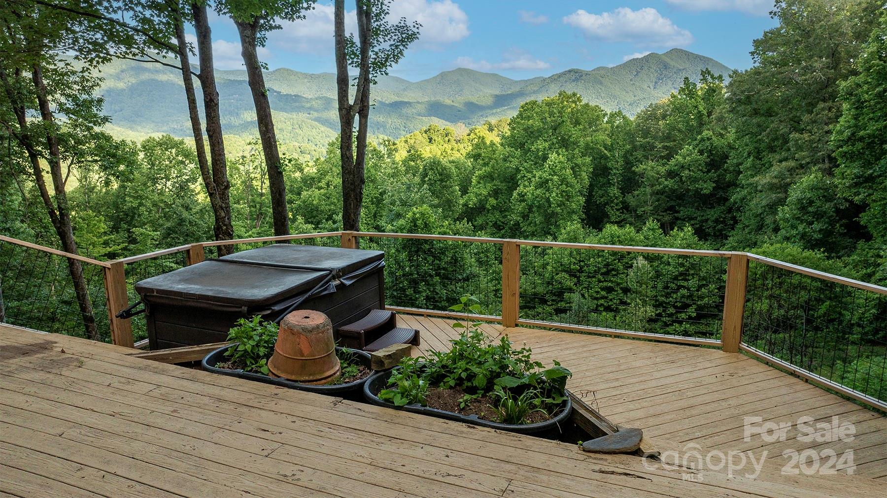 a view of a balcony with wooden floor and fence