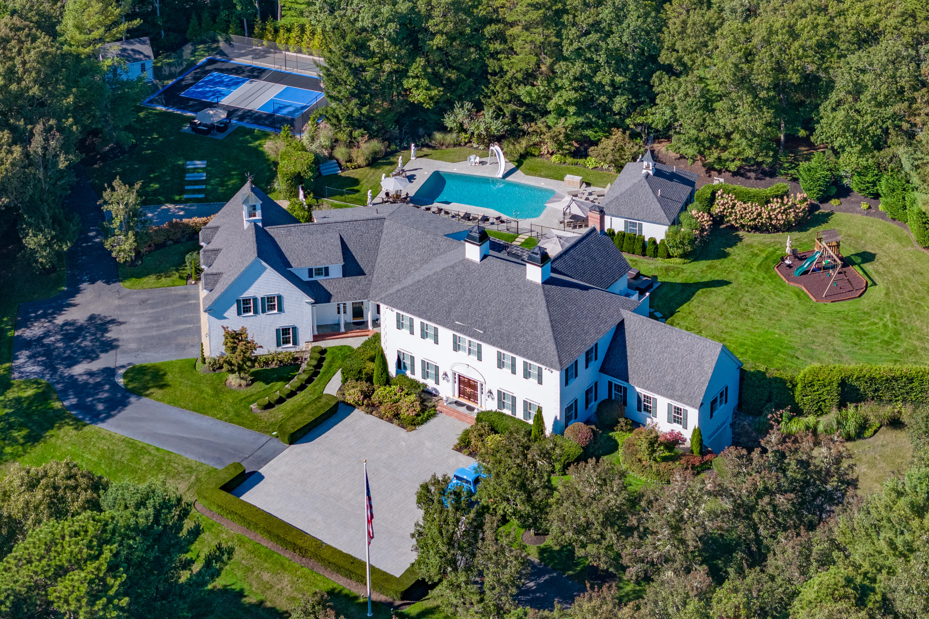 an aerial view of a house with a garden and swimming pool