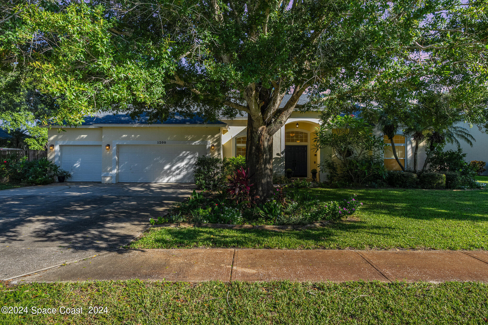 a front view of a house with garden