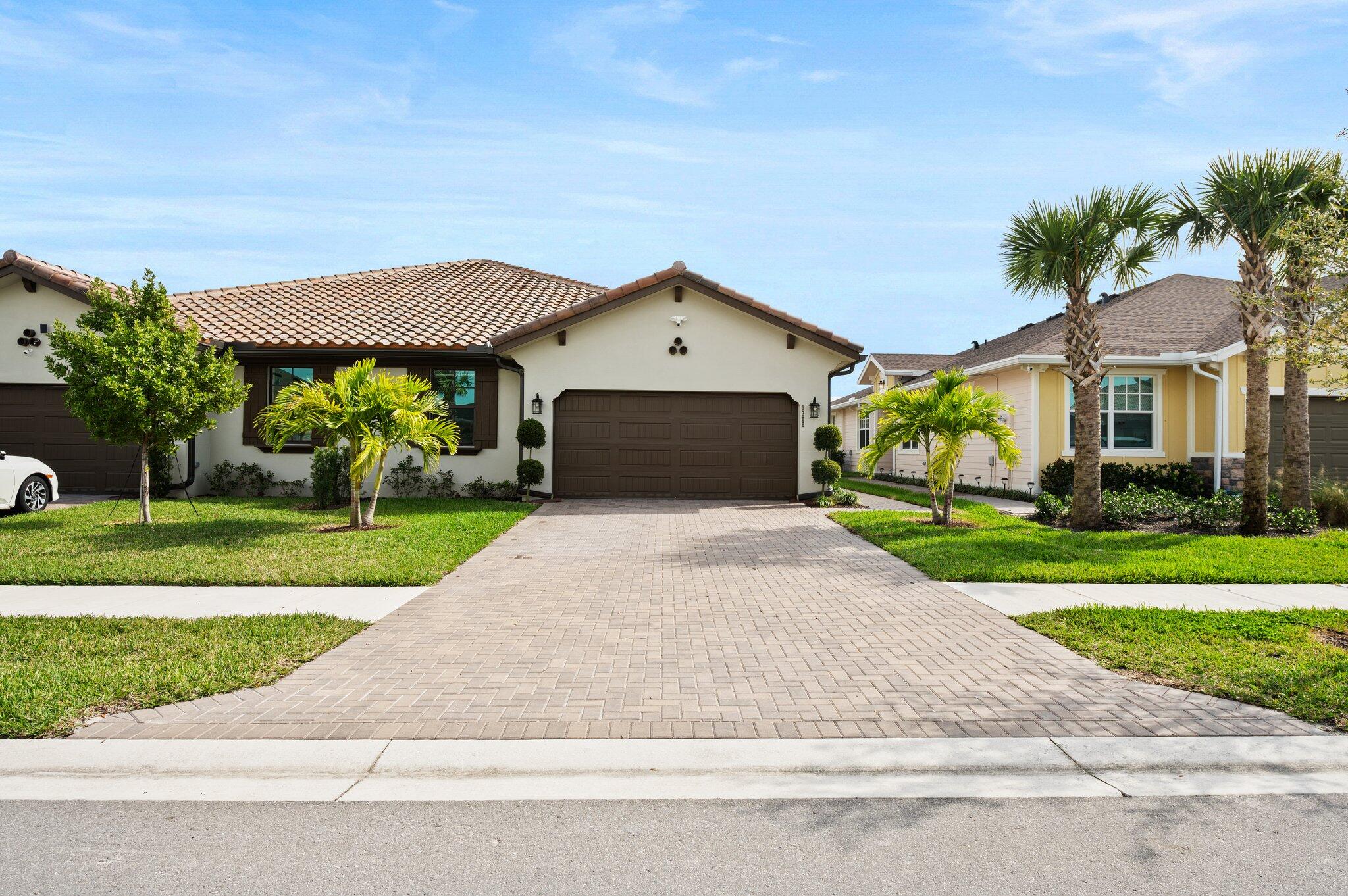 a front view of a house with a yard and garage