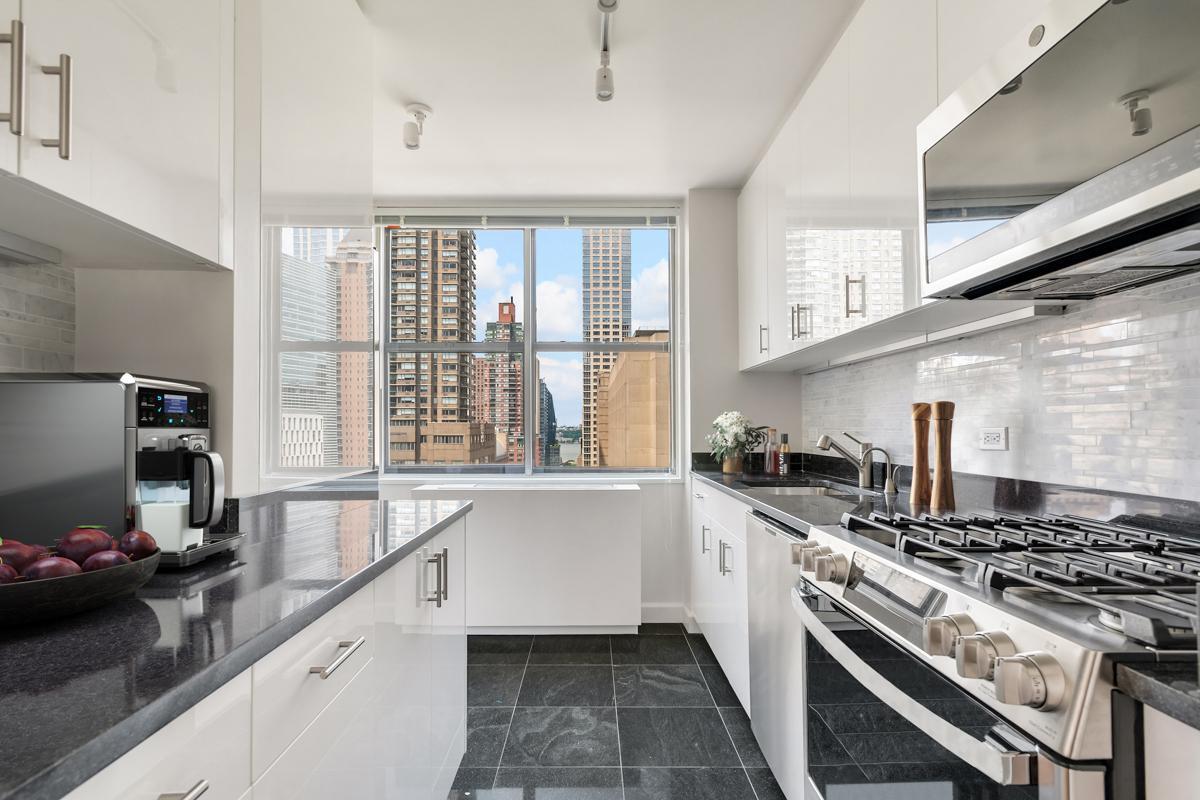 a kitchen with a stove a sink and a refrigerator