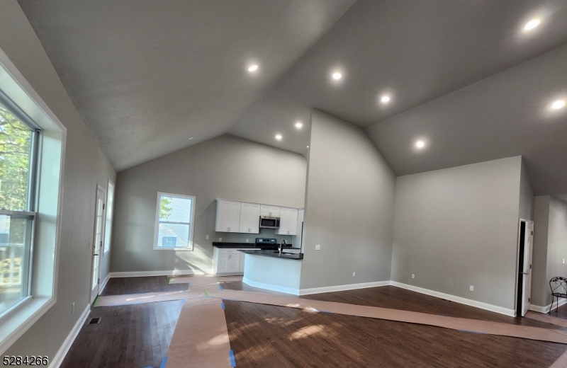 a view of a living room a window and wooden floor