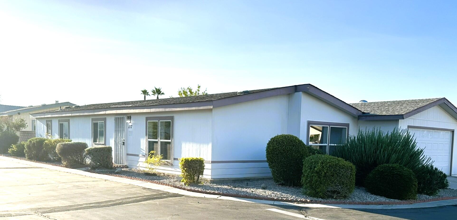 a view of a house with a yard and plants