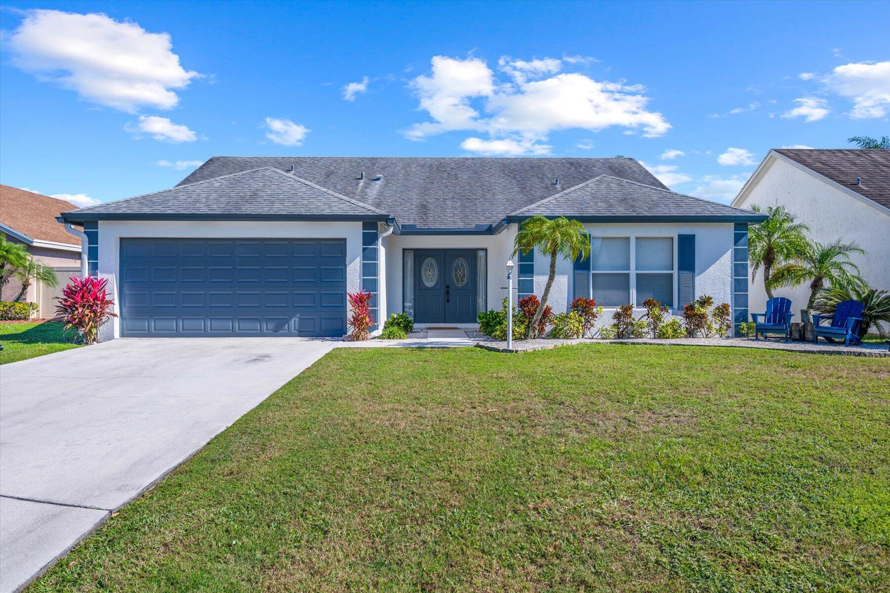 a front view of house with yard and outdoor seating