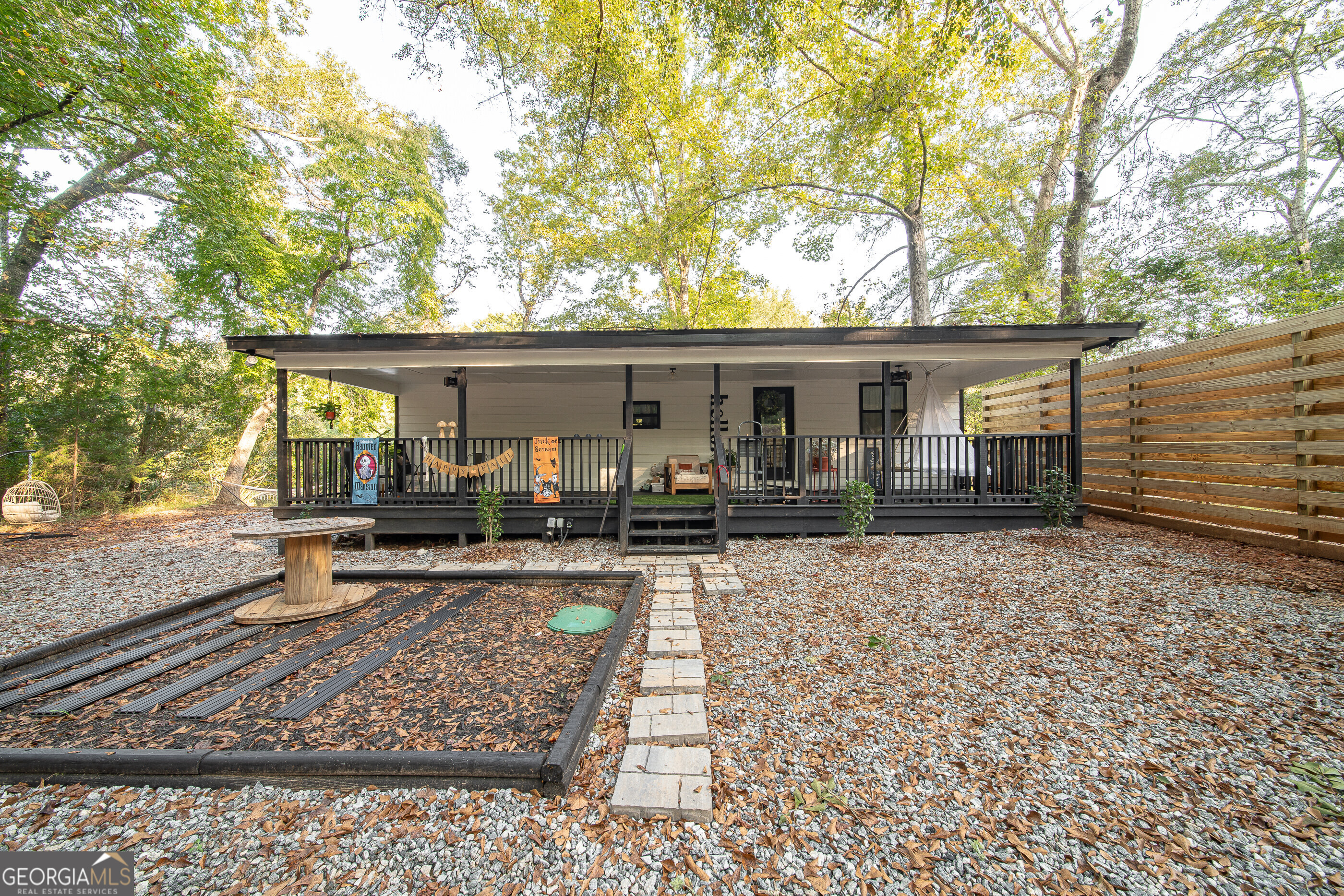 a front view of house with yard outdoor seating and barbeque oven