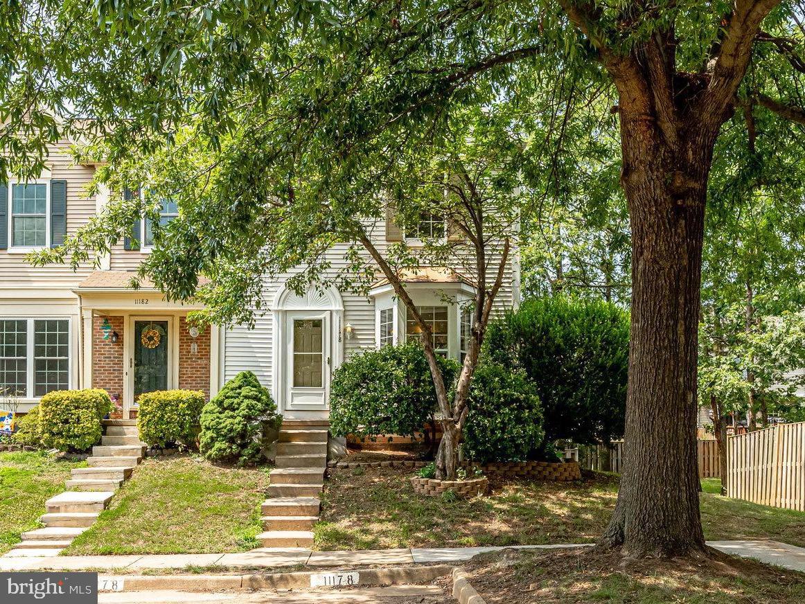 a view of a house with a tree in the background