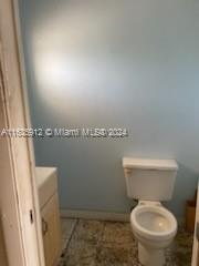 a white toilet sitting next to a shower