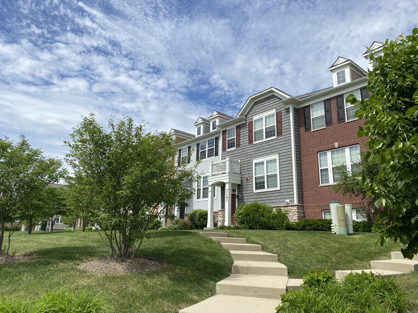 a front view of a house with a yard